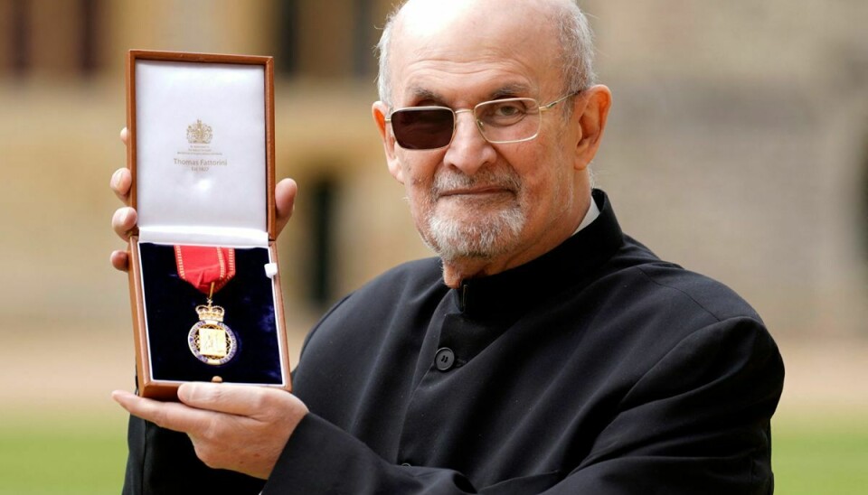 Den britiske forfatter Salman Rushdie poserer med sin orden.