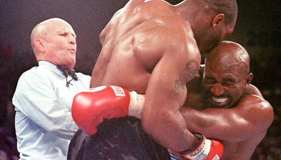 Mills Lane griber ind, da Tyson sætter tænderne i sin modstander.